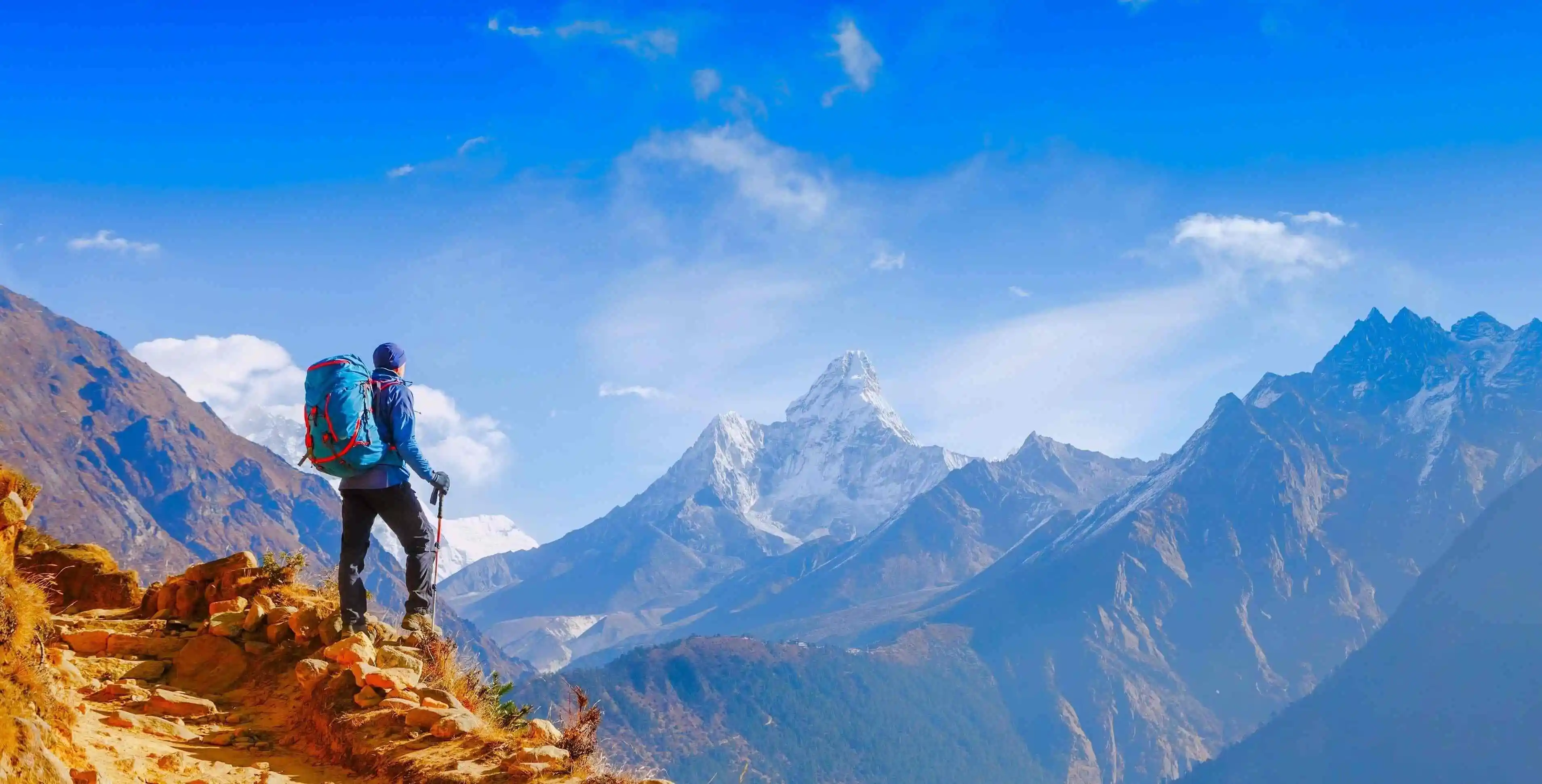 Image of a man with hiking equipment exploring some mountains
